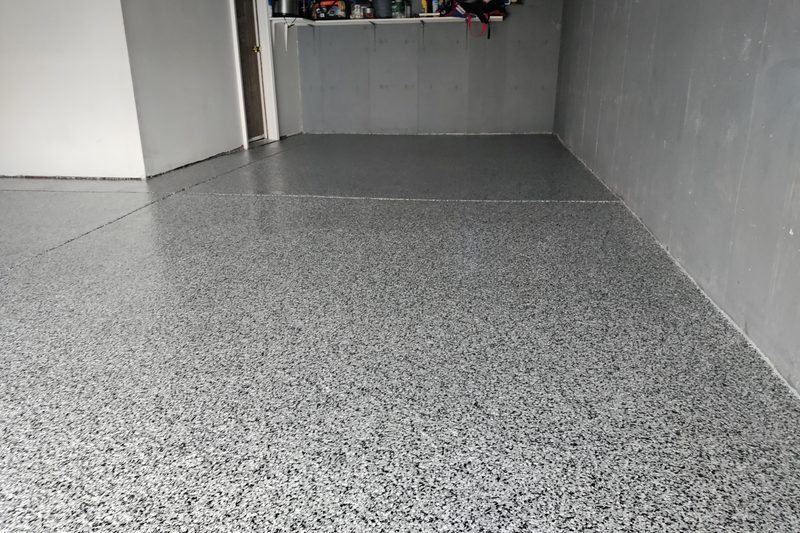 Freshly coated flake epoxy floor in a residential Denver garage