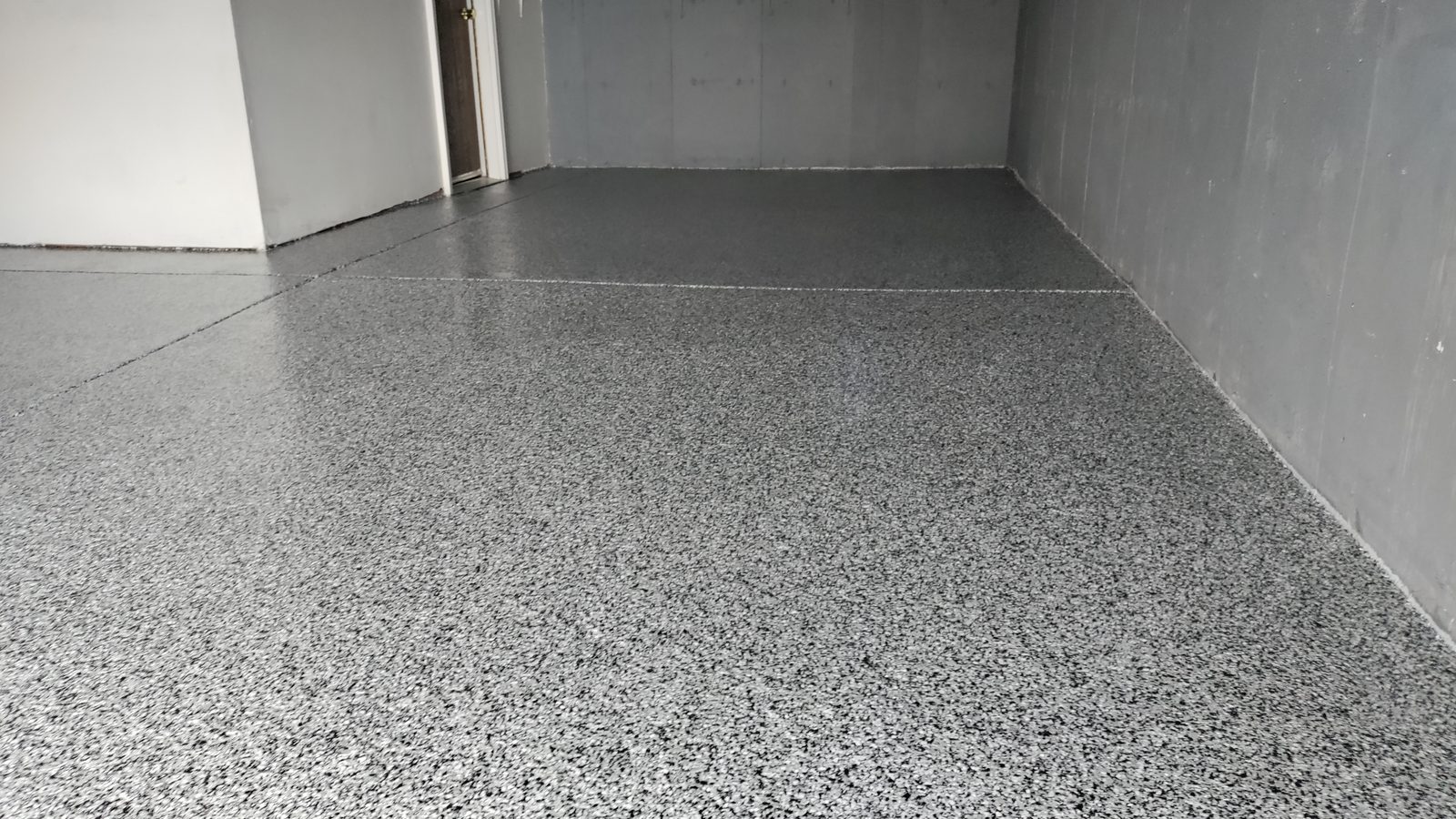Freshly coated flake epoxy floor in a residential Denver garage