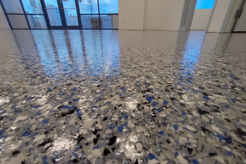 Vivid blue flake epoxy floor in a commercial Colorado space