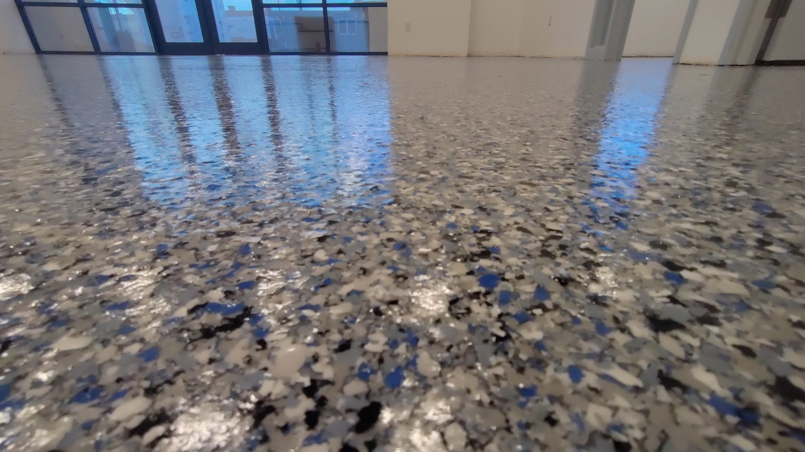 Vivid blue flake epoxy floor in a commercial Colorado space