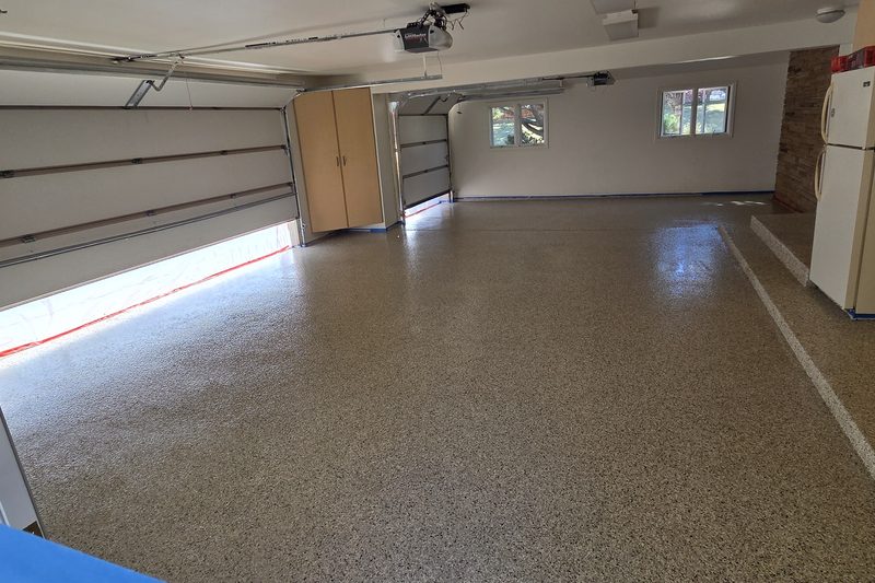 Wide flake epoxy garage floor in a three-car Colorado garage
