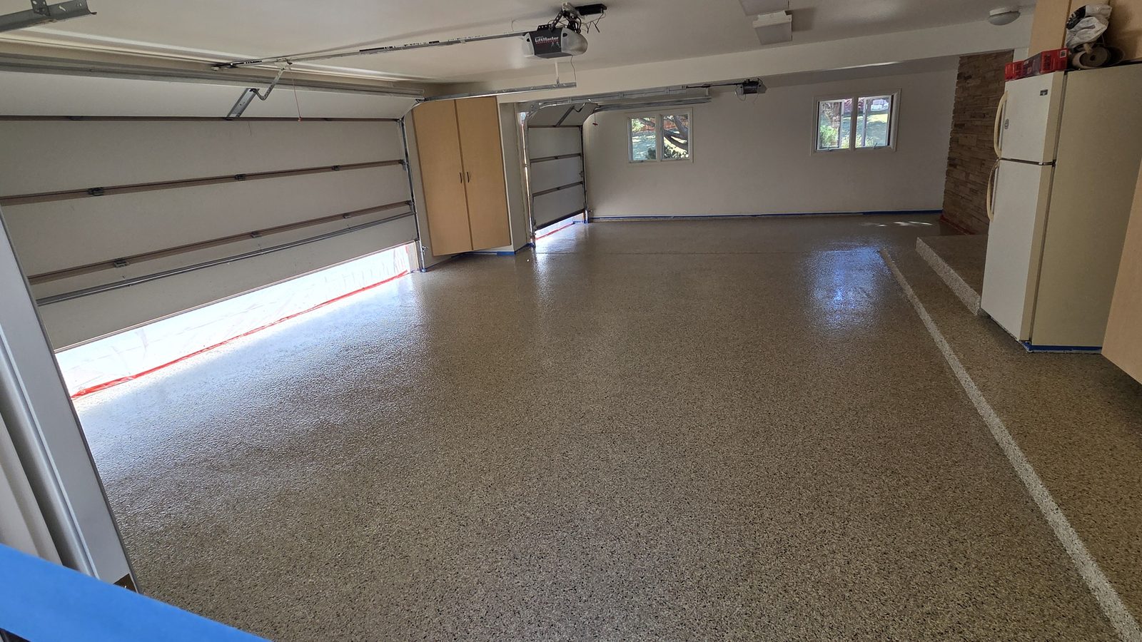 Wide flake epoxy garage floor in a three-car Colorado garage