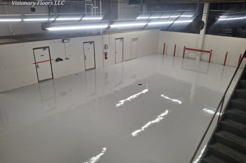 Glossy reflective epoxy floor in an industrial Colorado basement
