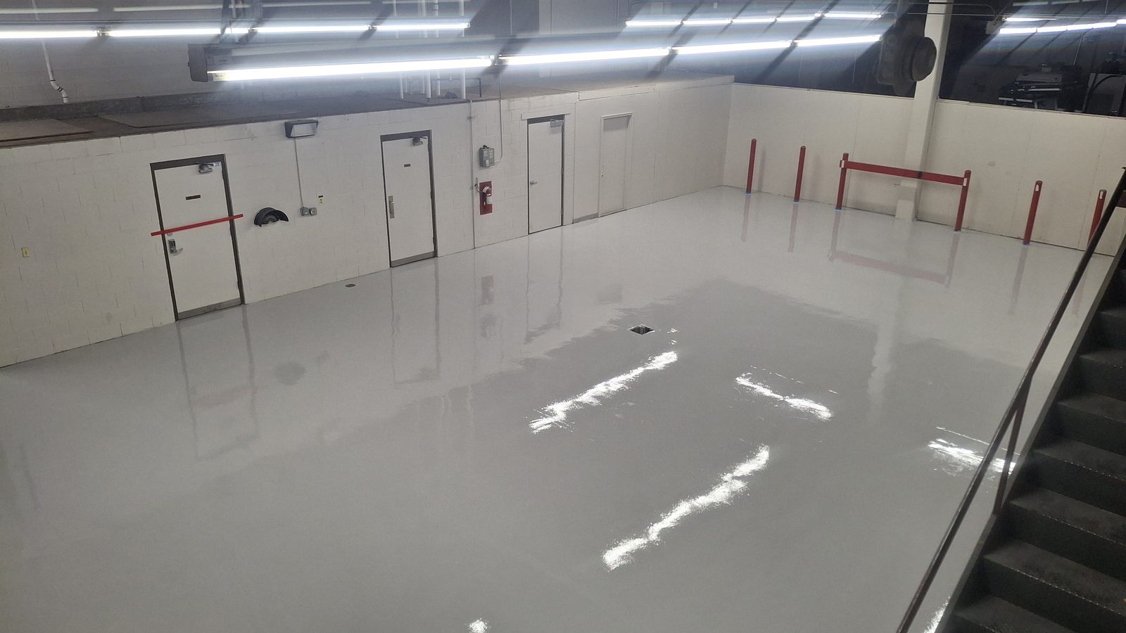 Glossy reflective epoxy floor in an industrial Colorado basement