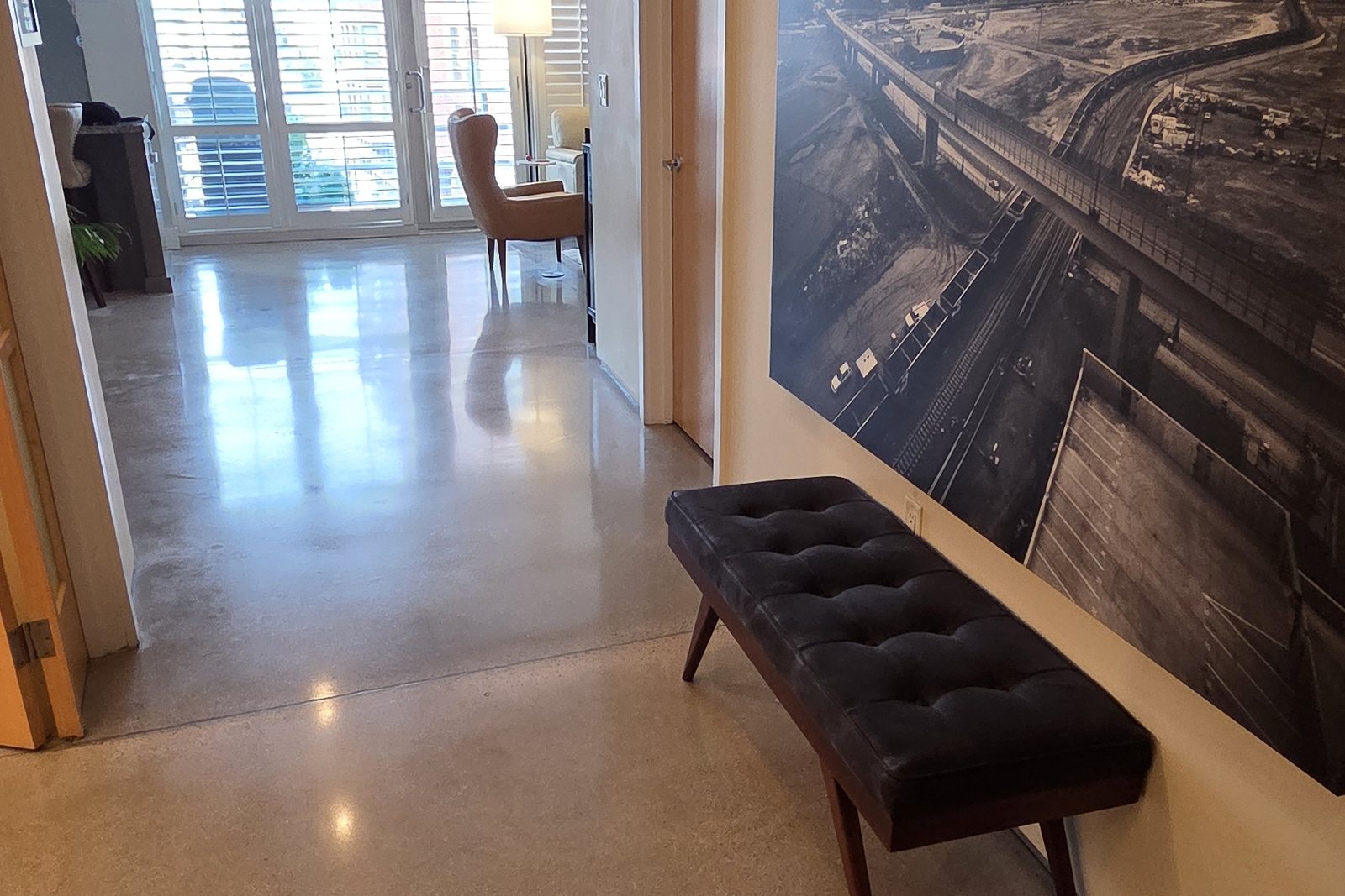 Polished concrete entry hallway in a Denver-area home, the kind of high-traffic zone where walk-off mats and dust mopping protect the finish