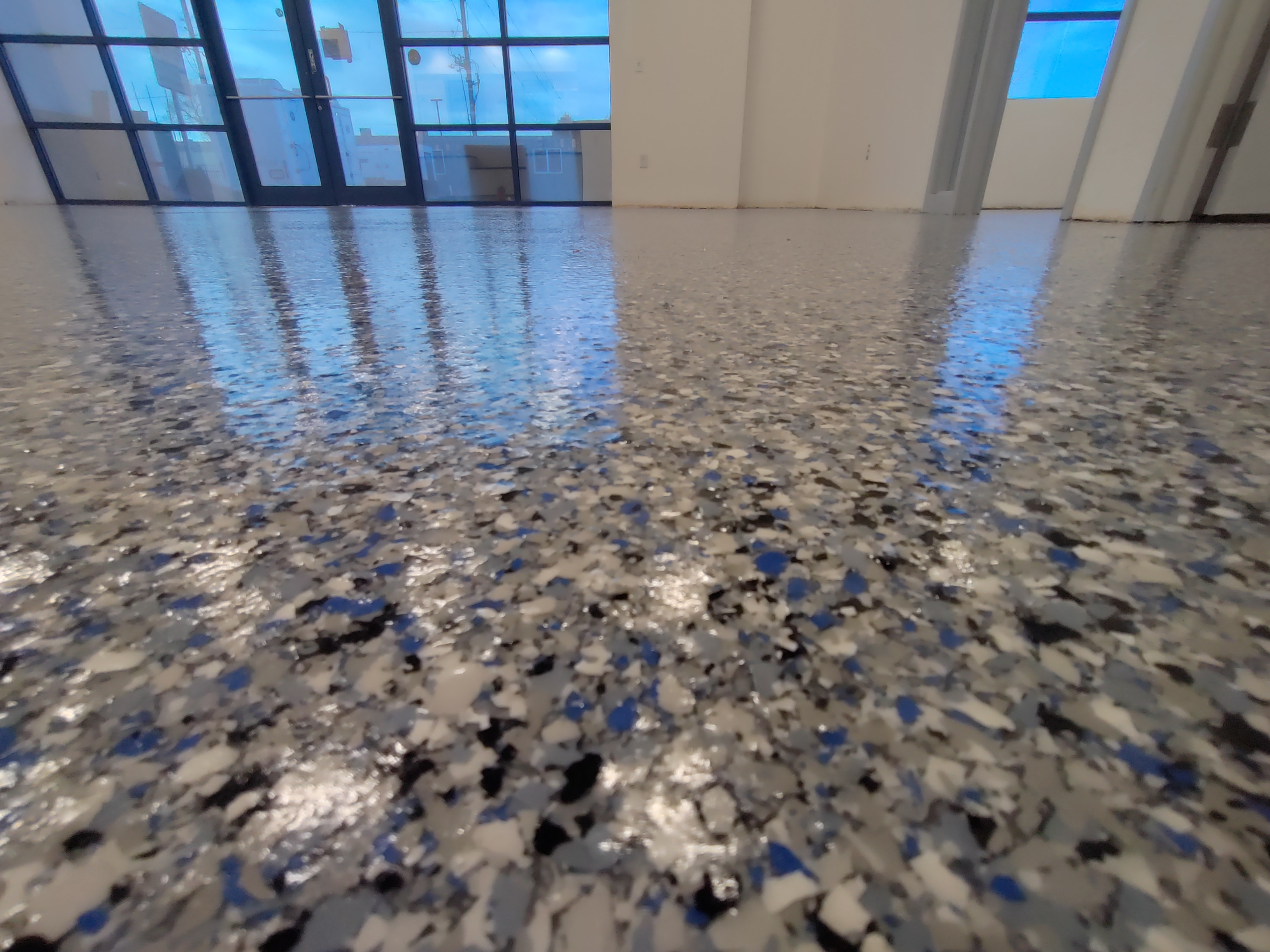 Blue gray and white flake epoxy with glossy urethane topcoat in commercial space — flake epoxy Denver