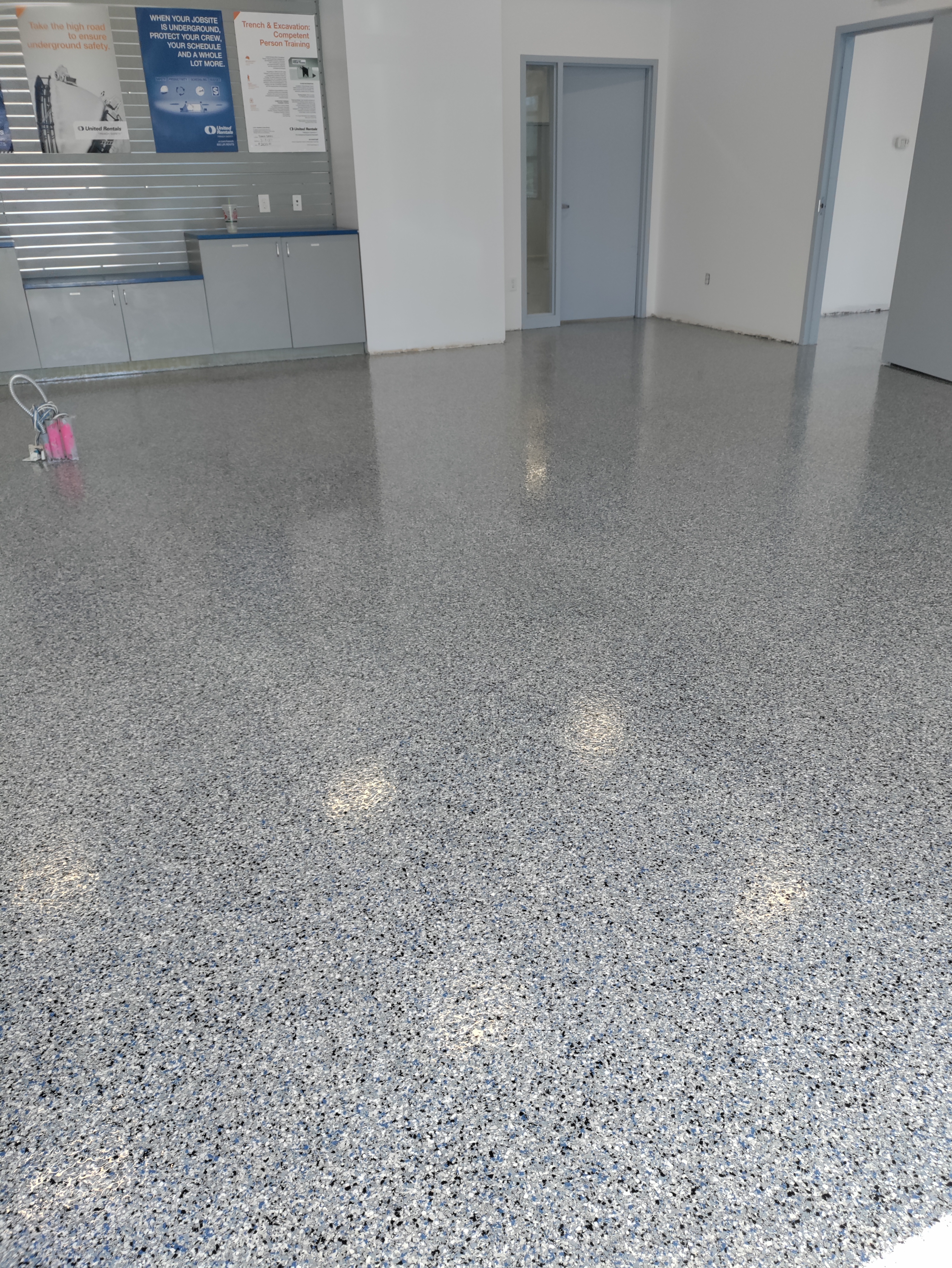 Flake epoxy in commercial office space with safety signage — commercial urethane coating Colorado
