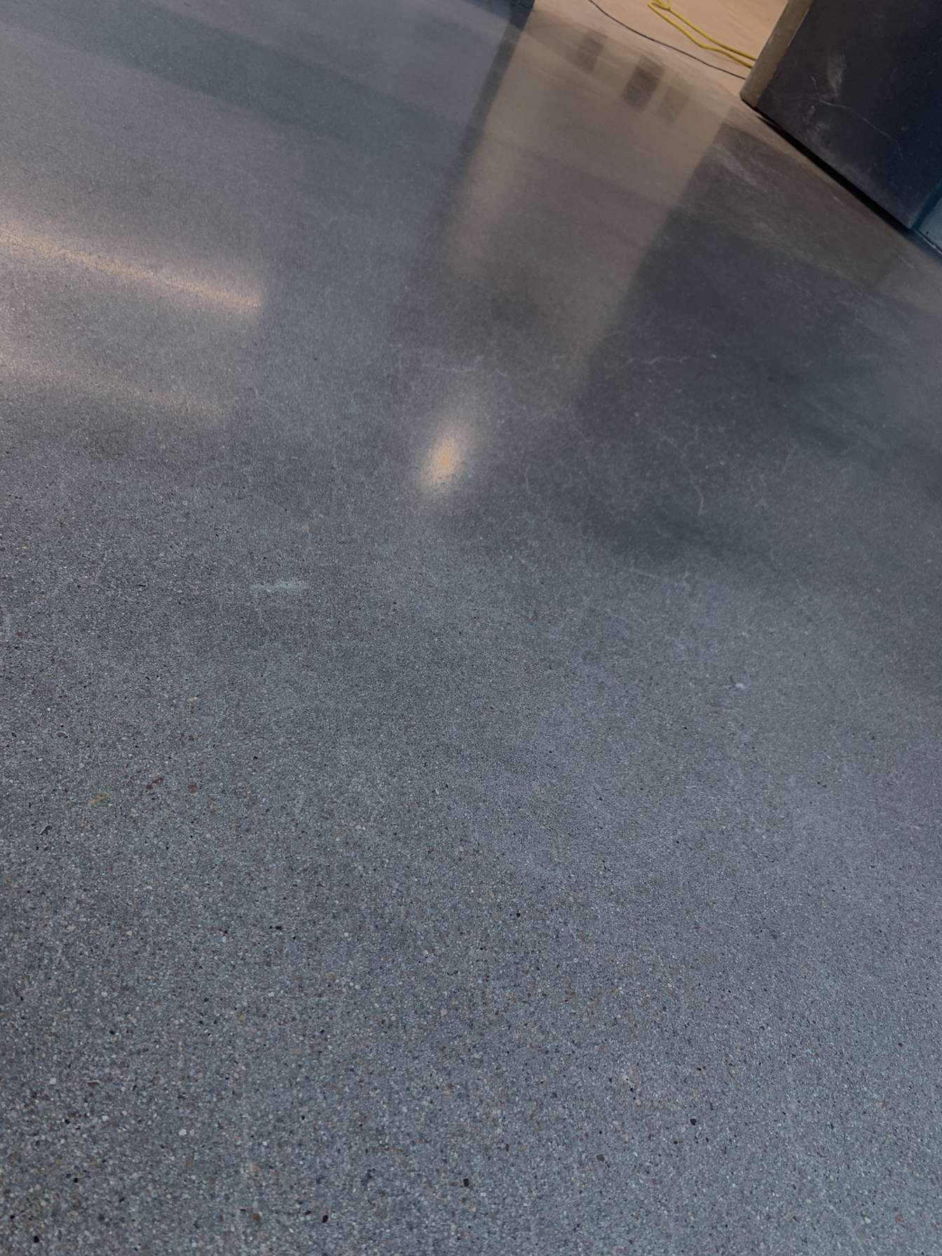 Close-up of high-gloss polished concrete surface showing aggregate detail and sheen