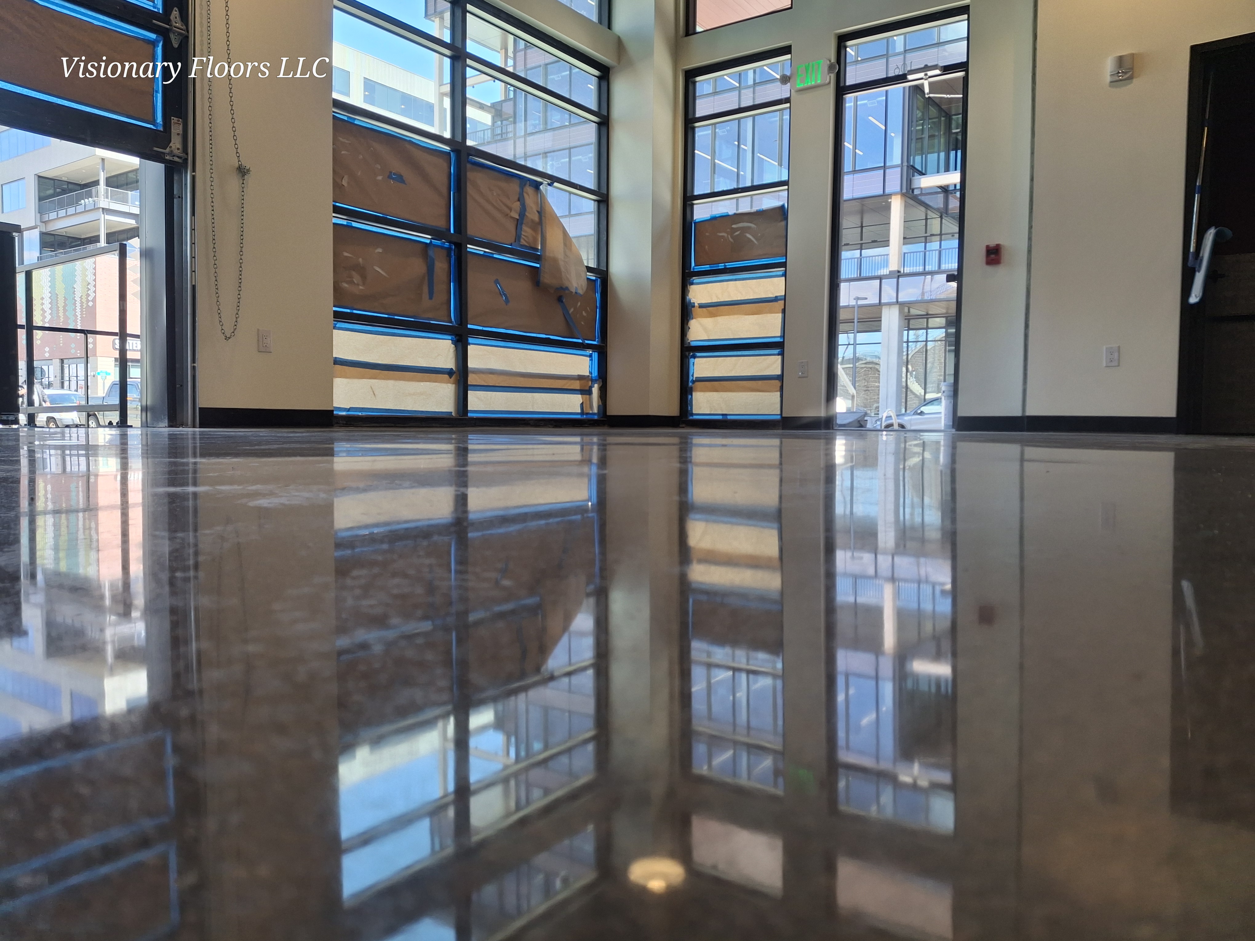 Mirror-finish polished concrete in commercial storefront with floor-to-ceiling windows — polished concrete Denver CO