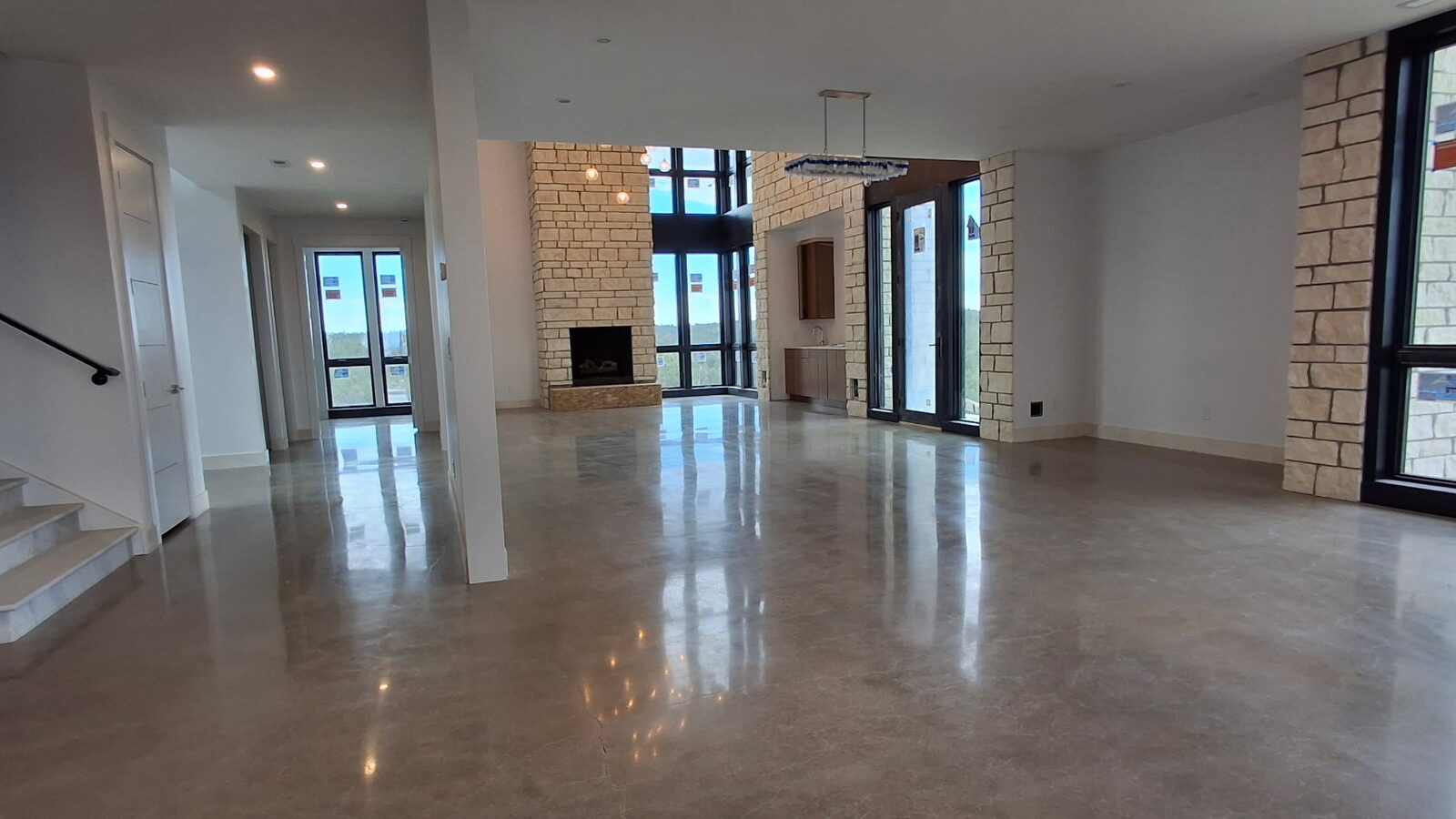 Mirror-finish polished concrete reflecting panoramic windows in luxury Colorado home